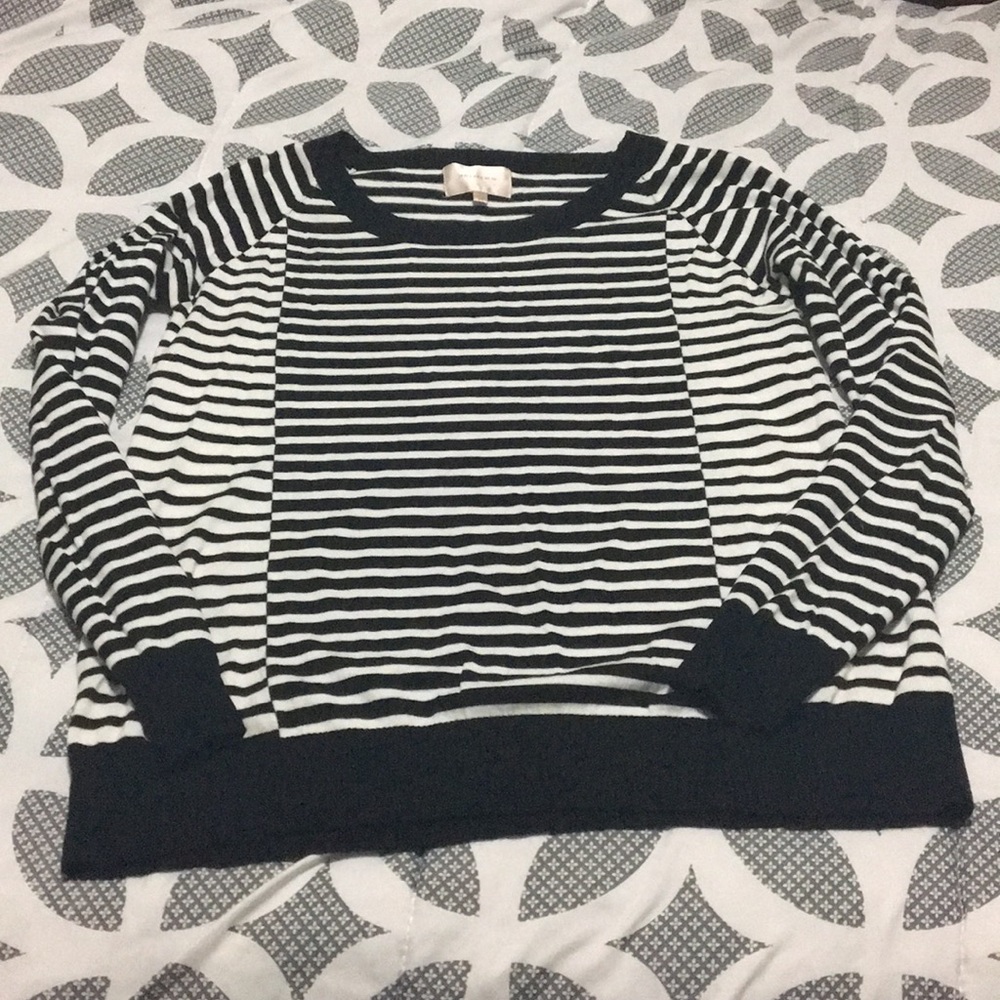 Skies are blue black and white striped sweater.